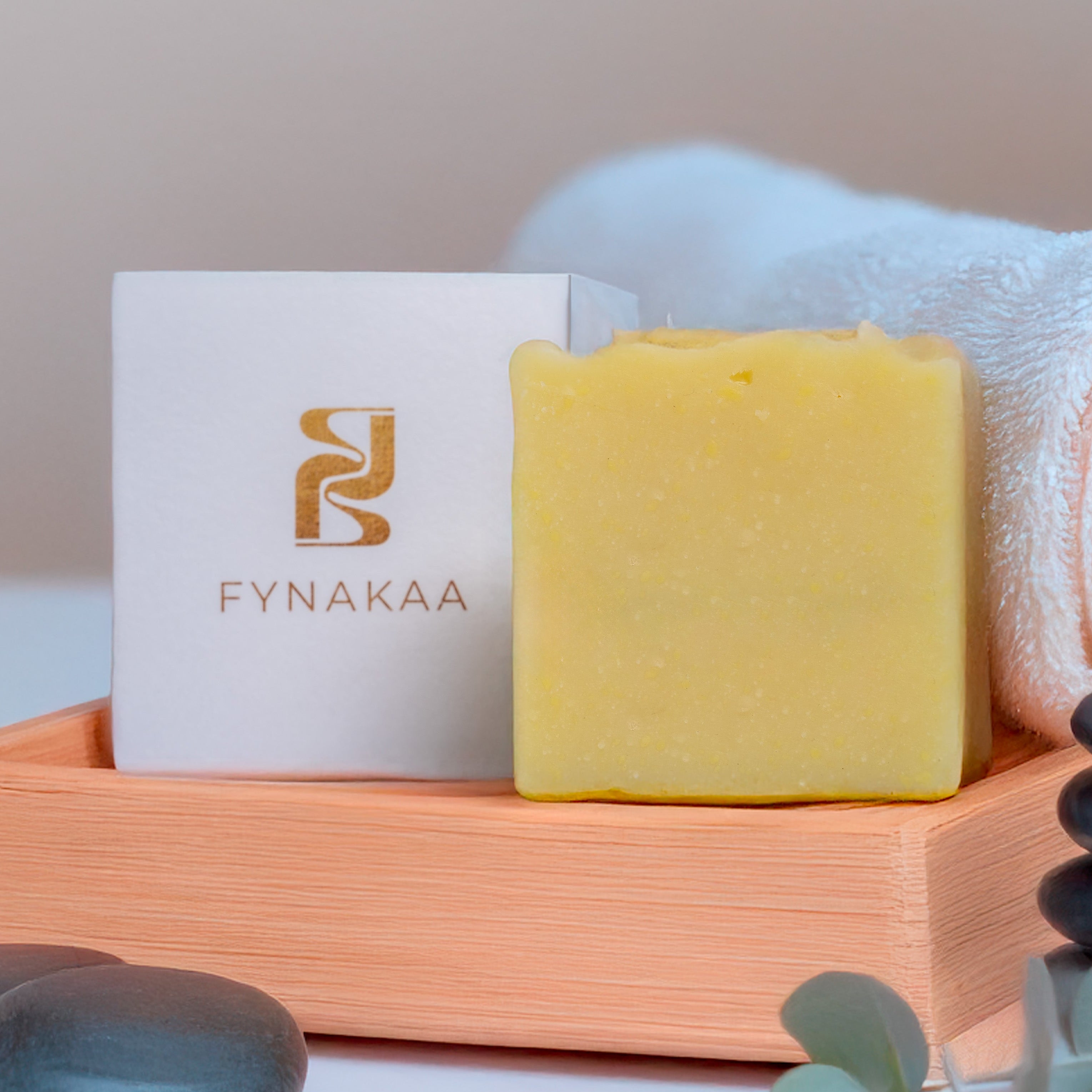 Fynakaa SHEA BUTTER Soap Bar with a towel and stones on a light background