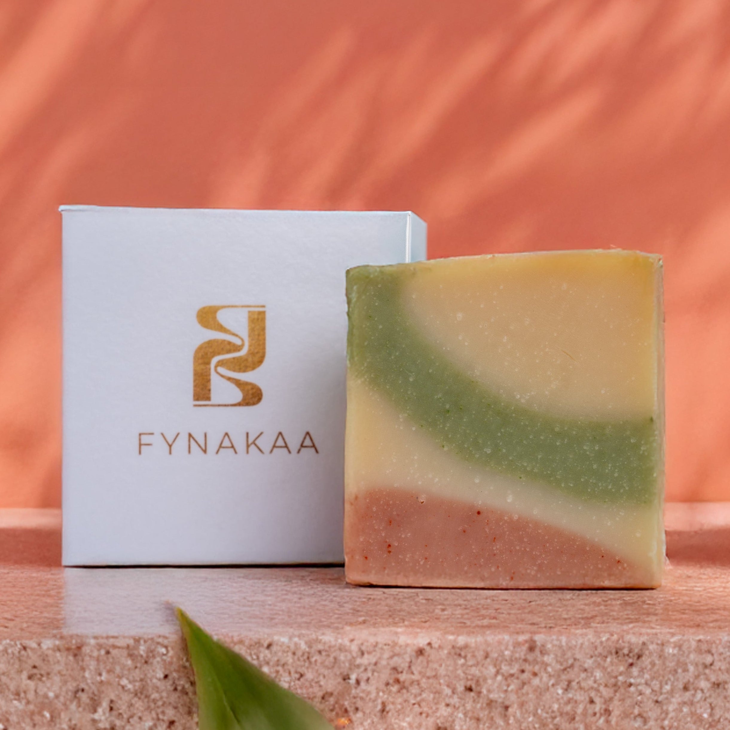 TRIPLE CLAY Bar of soap with a Fynakaa box on a stone surface with a natural background