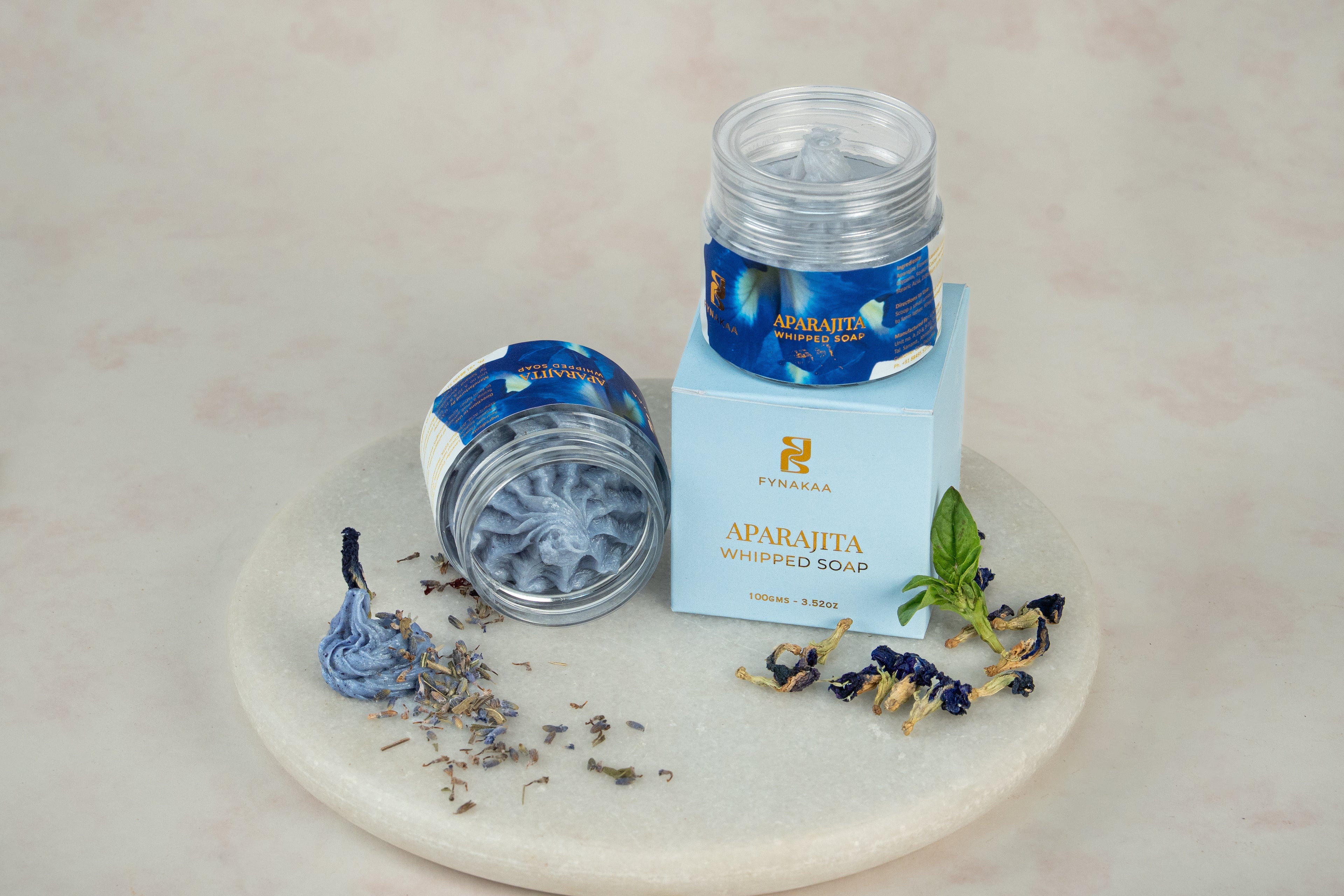 Aparajita whipped soap and packaging with a marble base and decorative elements.