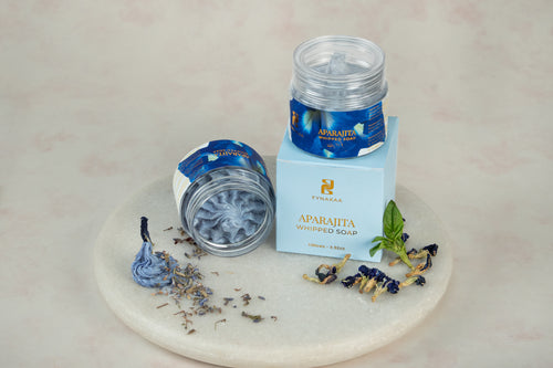 Aparajita whipped soap and packaging with a marble base and decorative elements.