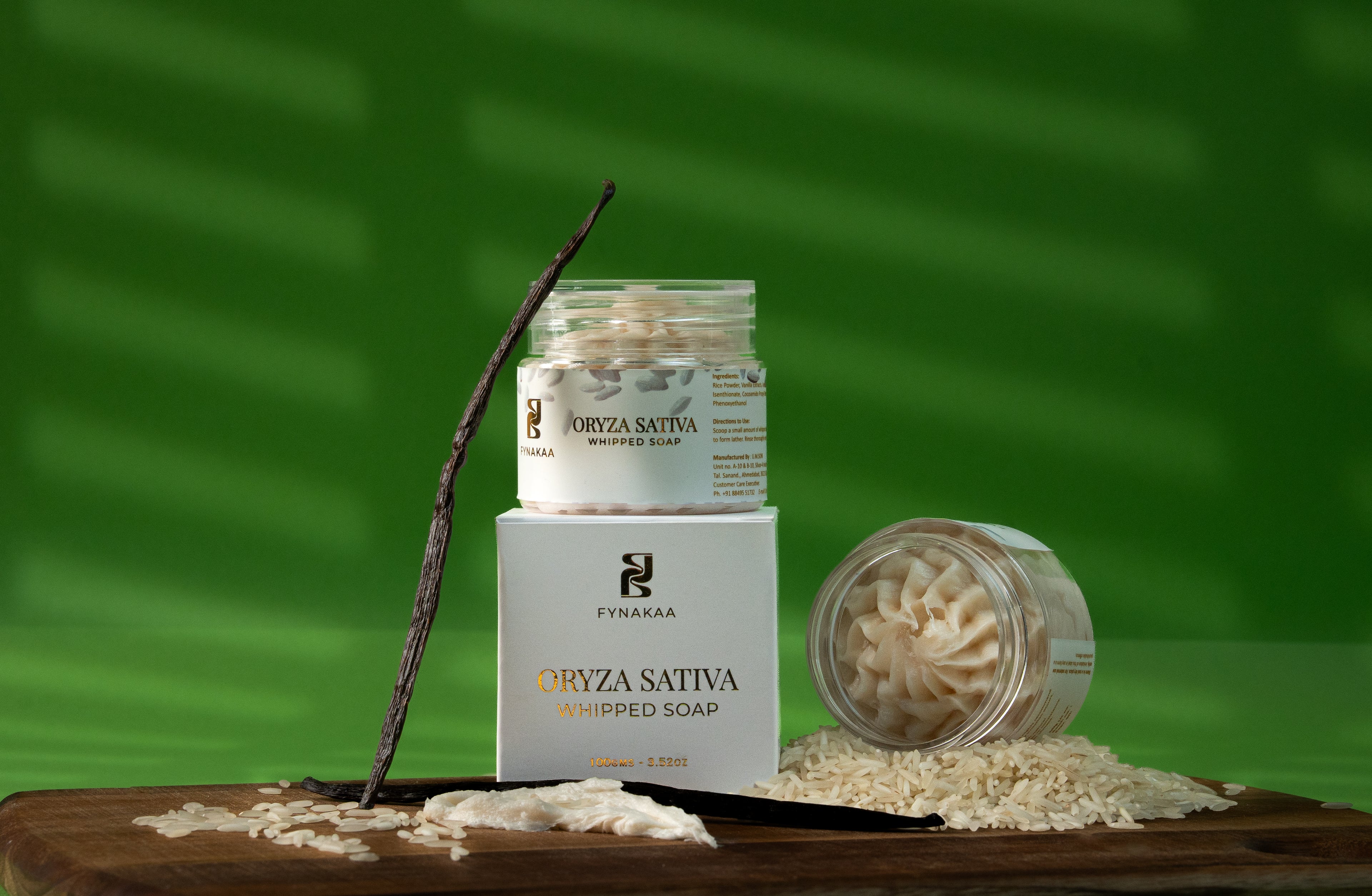 Oryza Sativa whipped soap on a wooden board with a green background