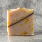 Fynakaa's Kesar Chandan Luxury Soap with clear and visible texture with a marble backdrop