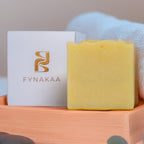 Fynakaa SHEA BUTTER Soap Bar with a towel and stones on a light background