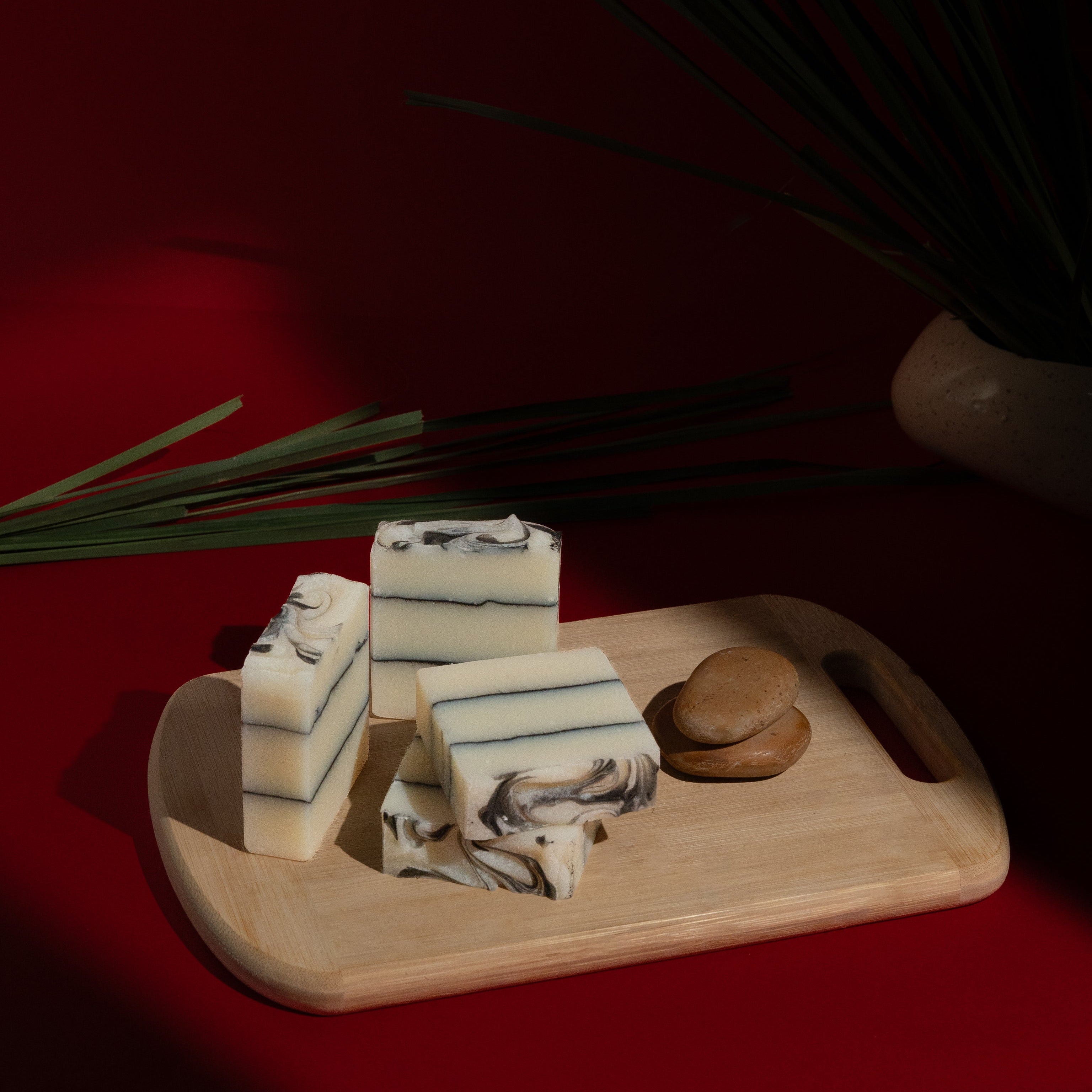 Wooden cutting board with soap on a dark red background